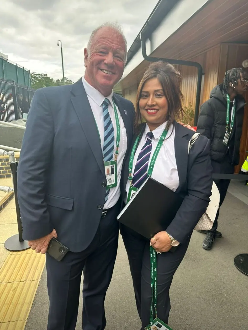 Two RMSS Ltd colleagues posing for a photo at a sports venue