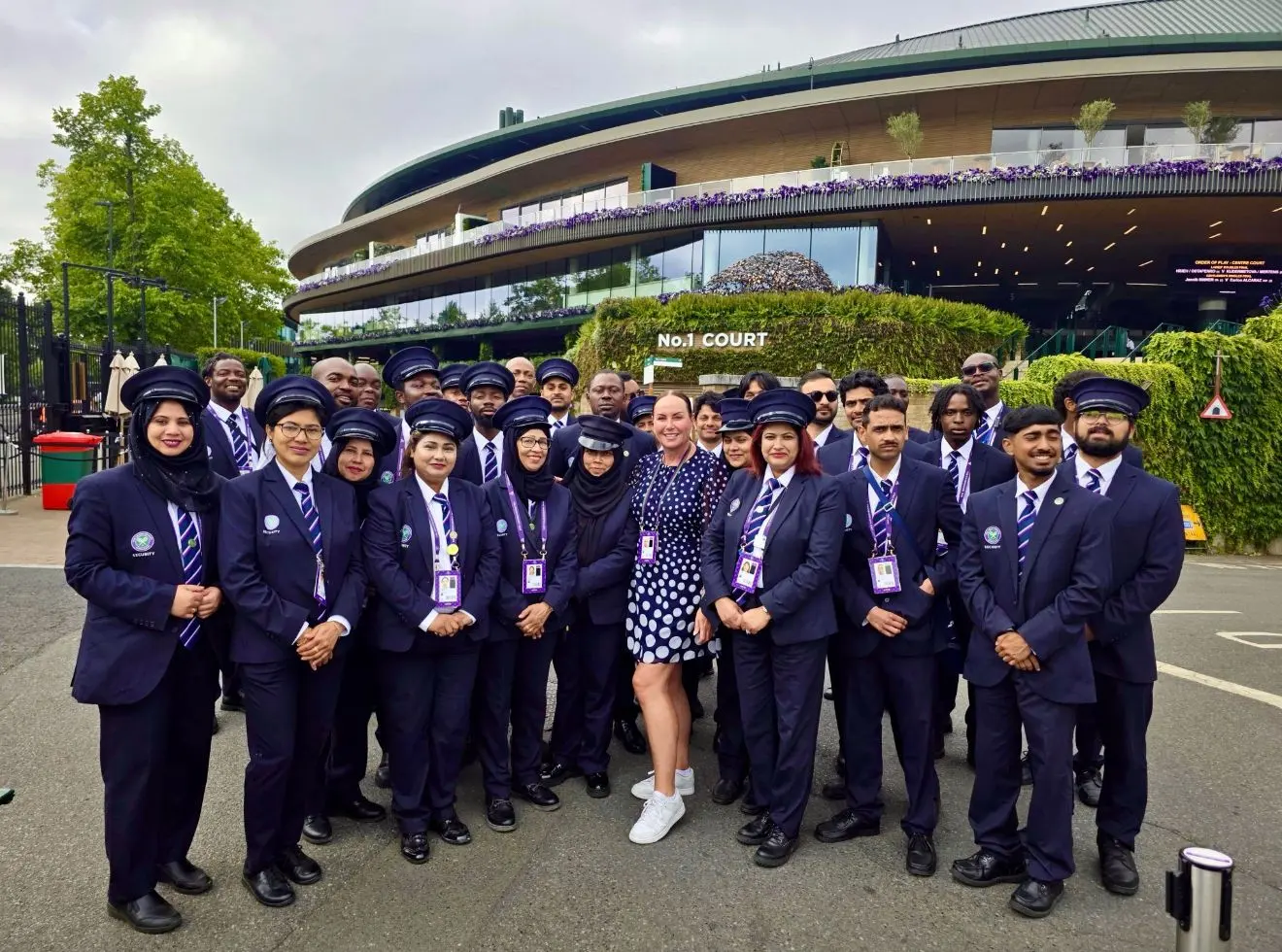 RMSS Ltd team in navy uniforms lined up together outside a sports ground